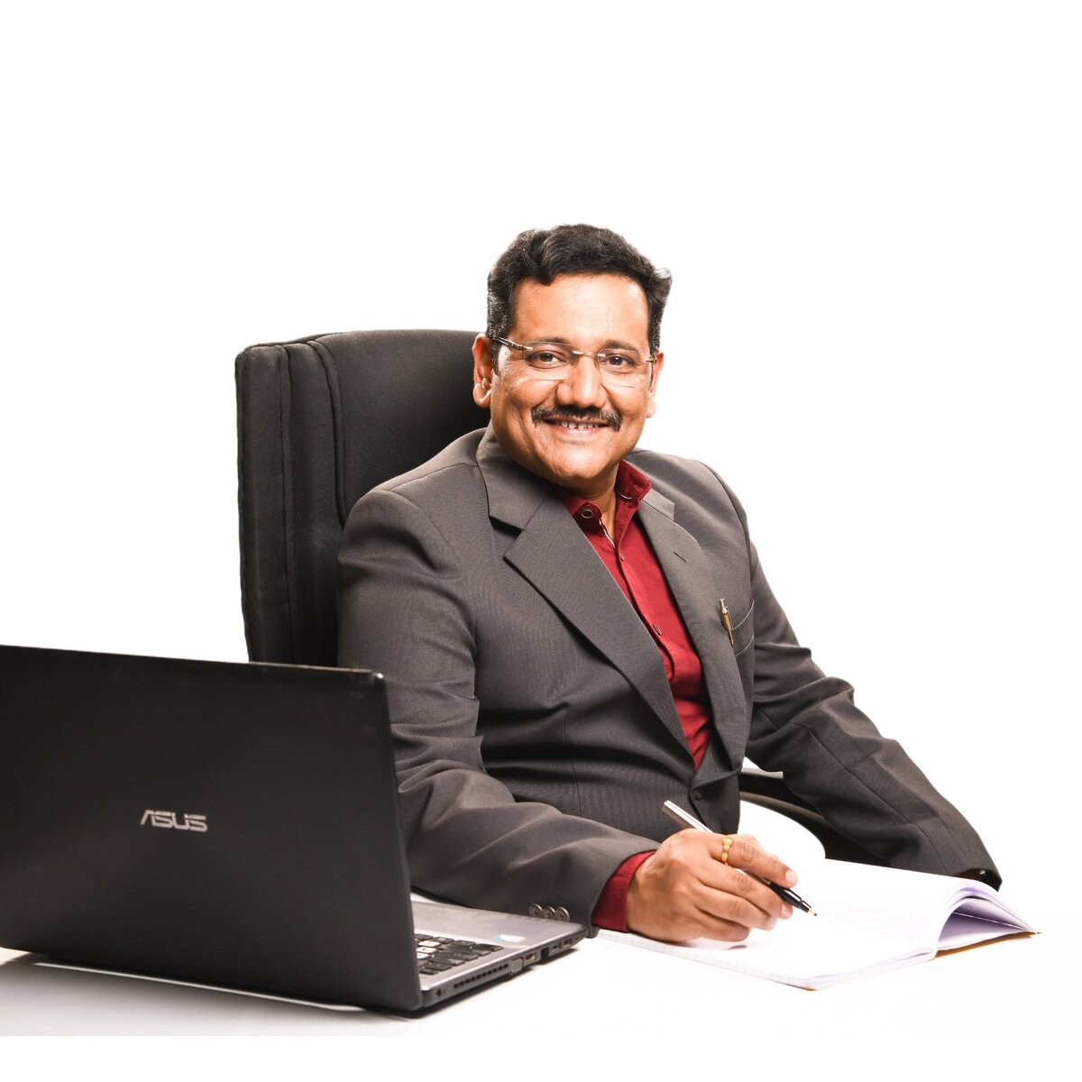 Vijay Vasantrao Bachulkar at his Vruddhi Investment office desk, Satara